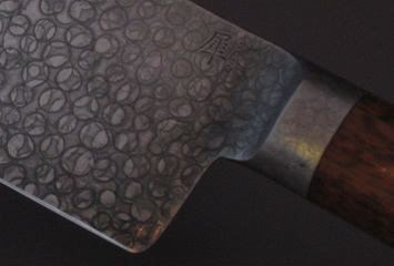 chef's knife with integral bolster closeup of kanji
